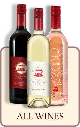 Three bottles of wine are sitting next to each other on a table.