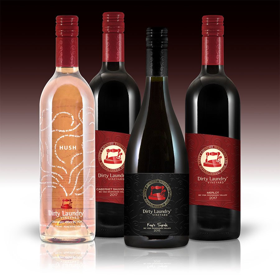 Four bottles of dirty laundry wine are lined up next to each other