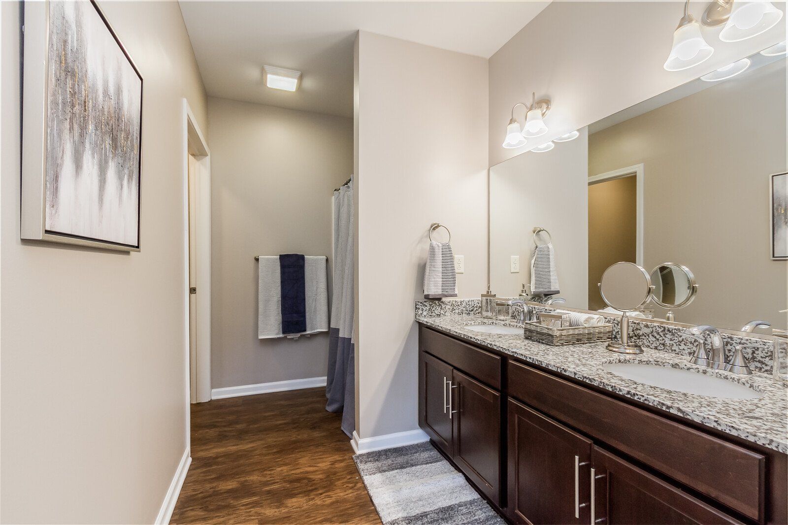 Primary bathroom with double sinks and granite countertops