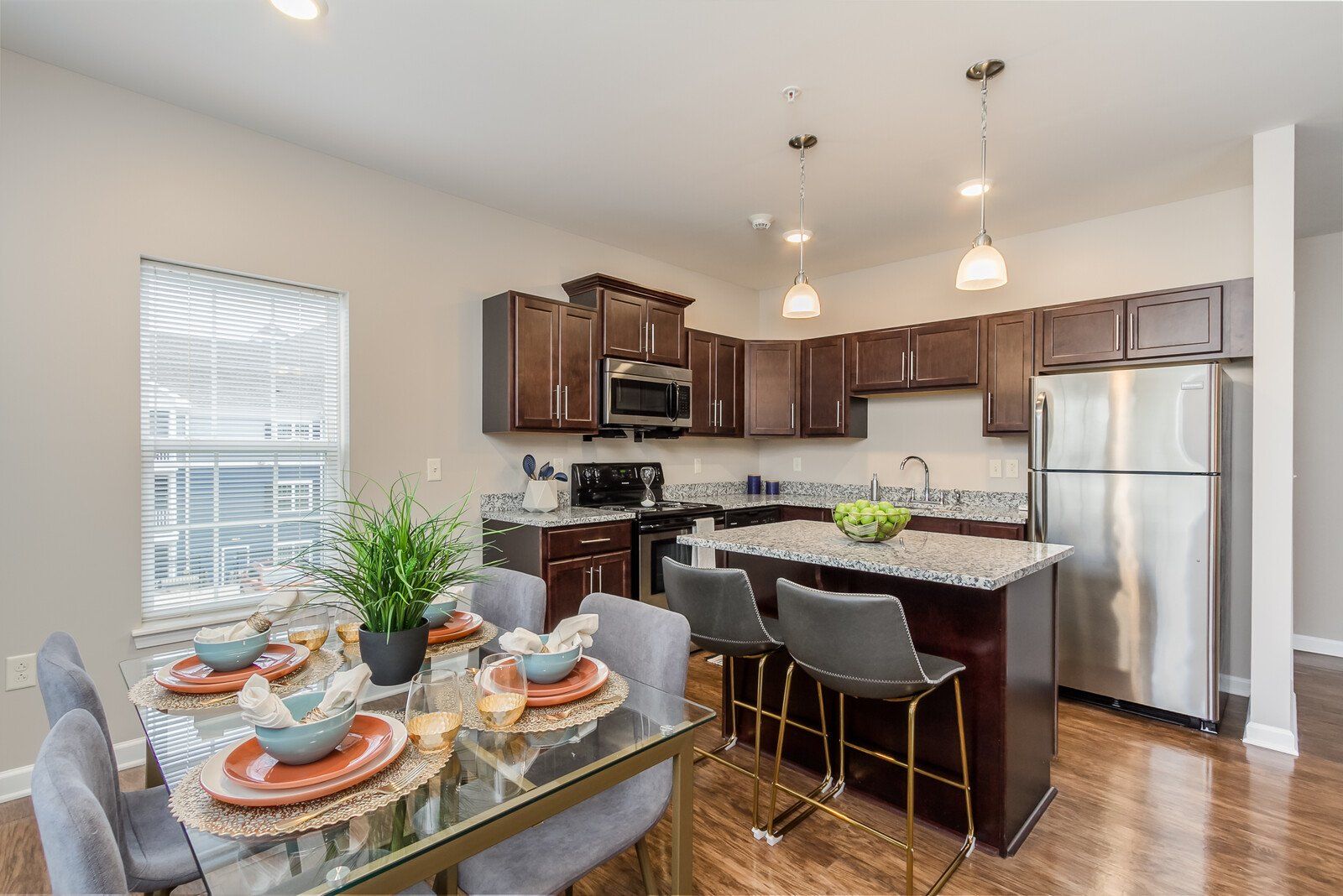 Open concept kitchen with island and dark cabinets