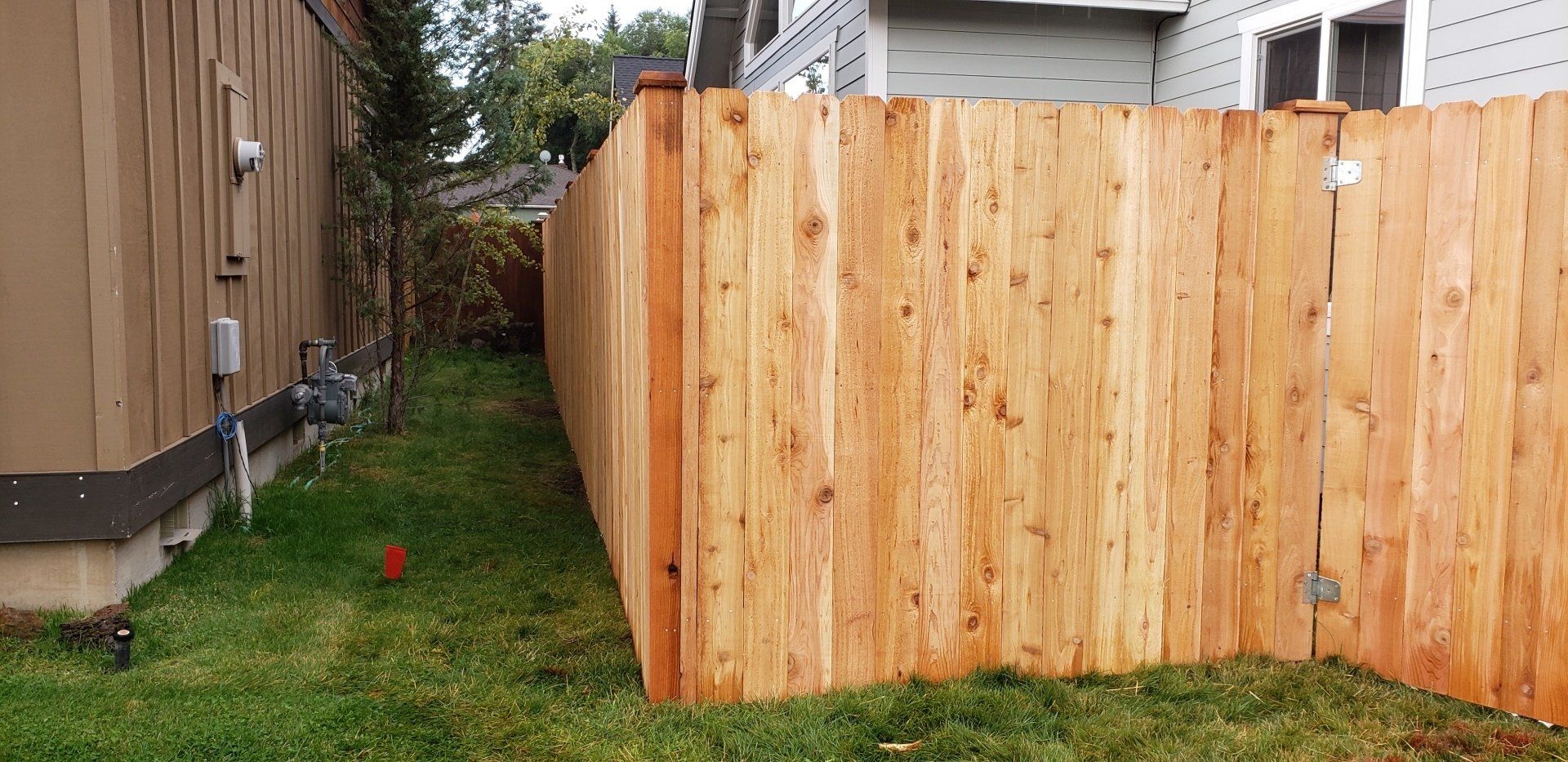 Wooden fence corner installation in residential backyard