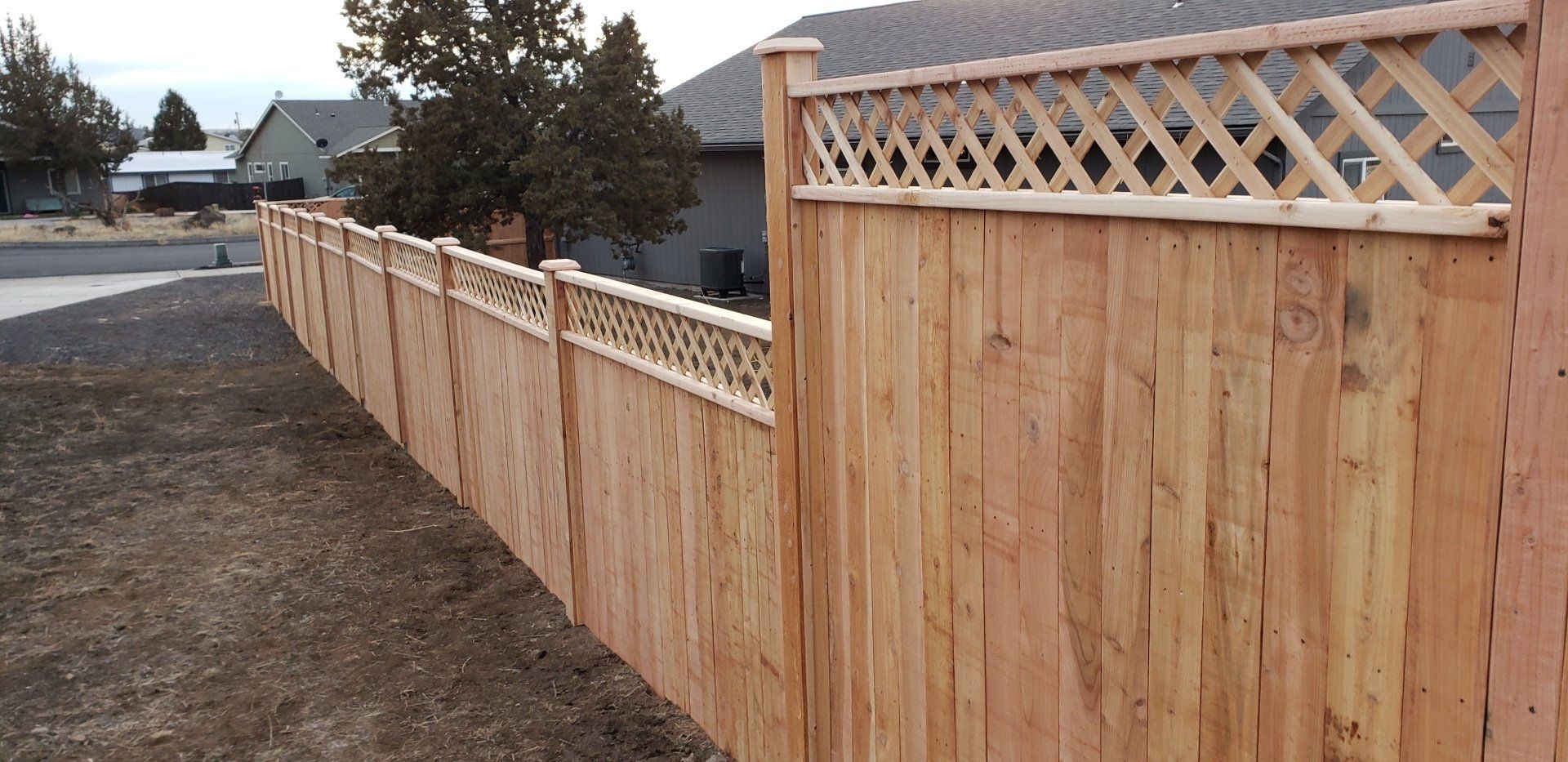 Decorative wooden fence with lattice top design