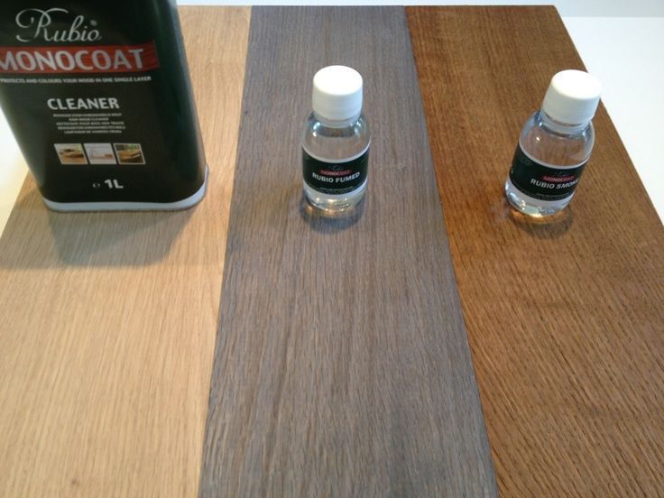 Cleaner bottle and two small dropper bottles on wood-grain sample boards