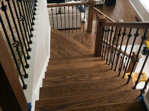 Staircase with dark wood steps and black railings in a home hallway