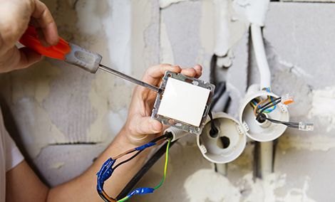 Electrician repairing the electrical switch