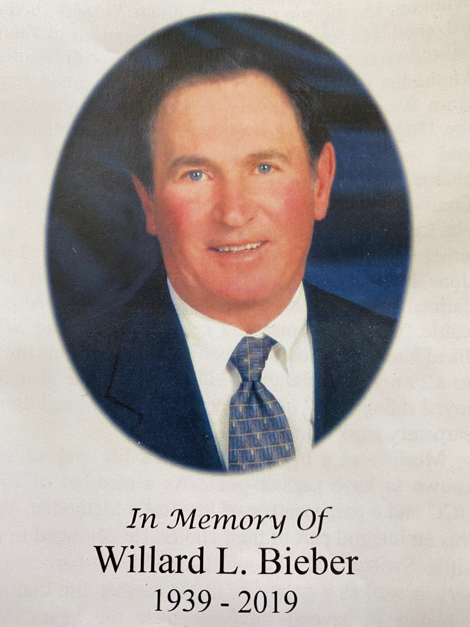 Oval portrait of Willard L. Bieber, wearing a suit and tie; text