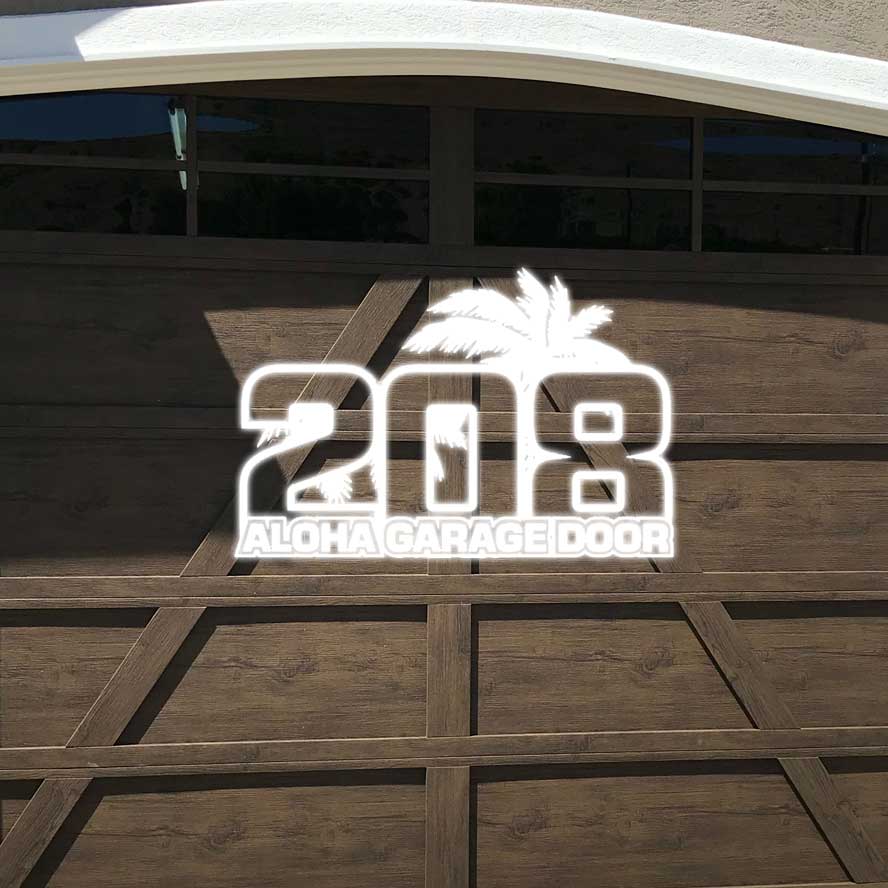 A wooden garage door with the logo for 208 Aloha Garage Door.