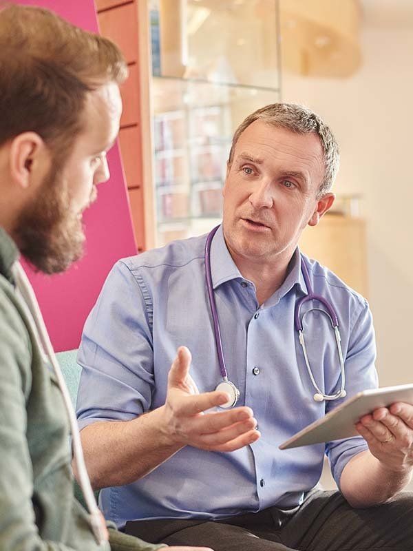 Male doctor consulting at a GP practice