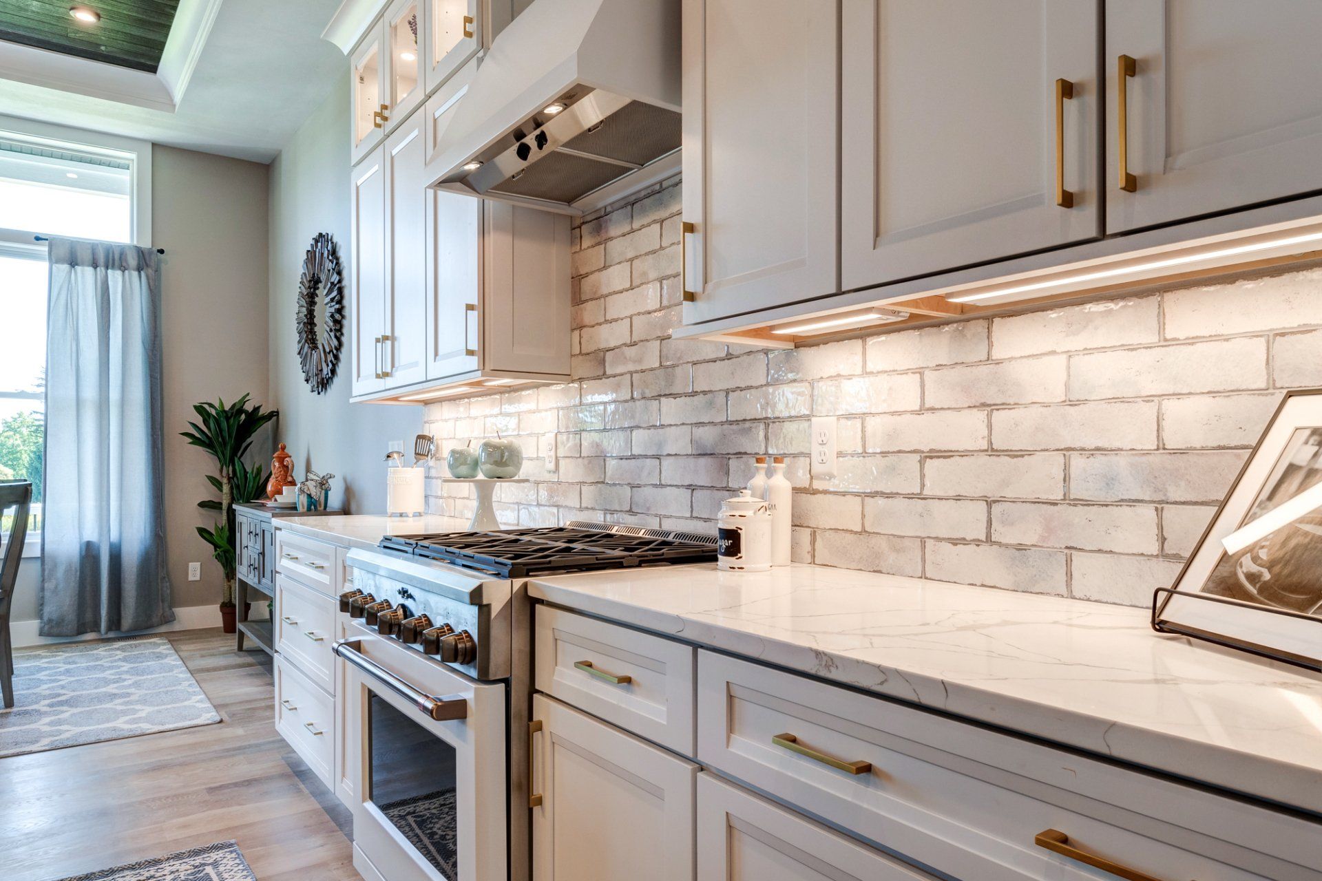kitchen with gas range and under cabinet lighting