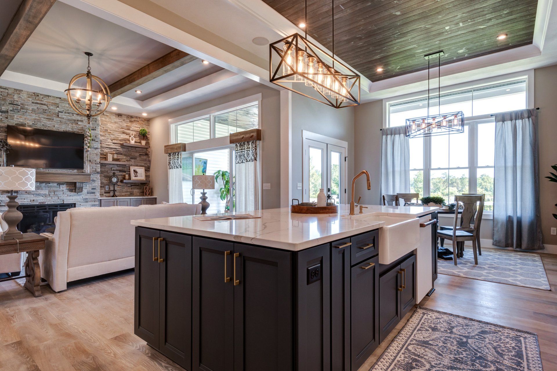 kitchen with recessed ceiling and living room in background