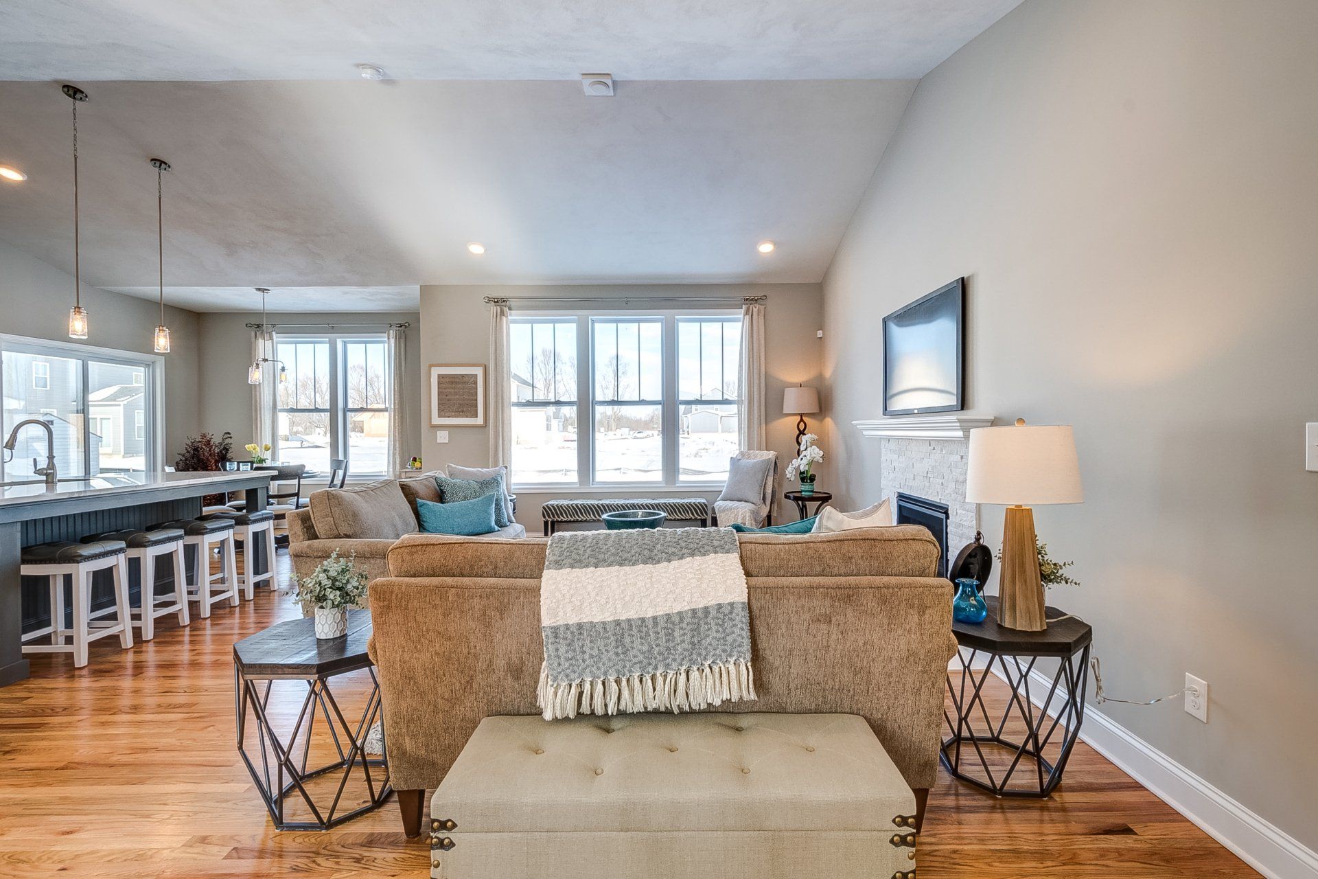 couch facing windows and two end tables