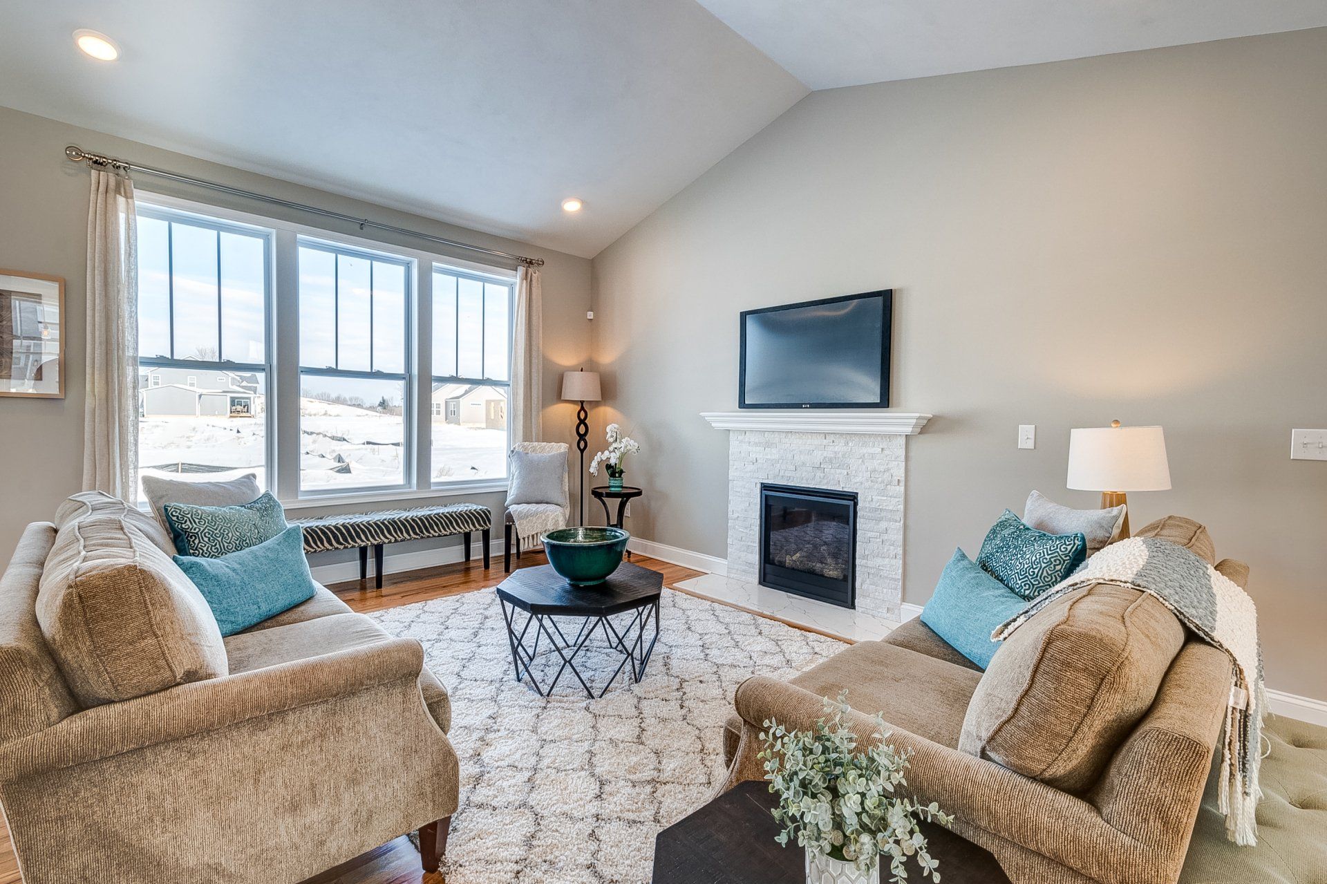 living room with fireplace and vaulted ceilings