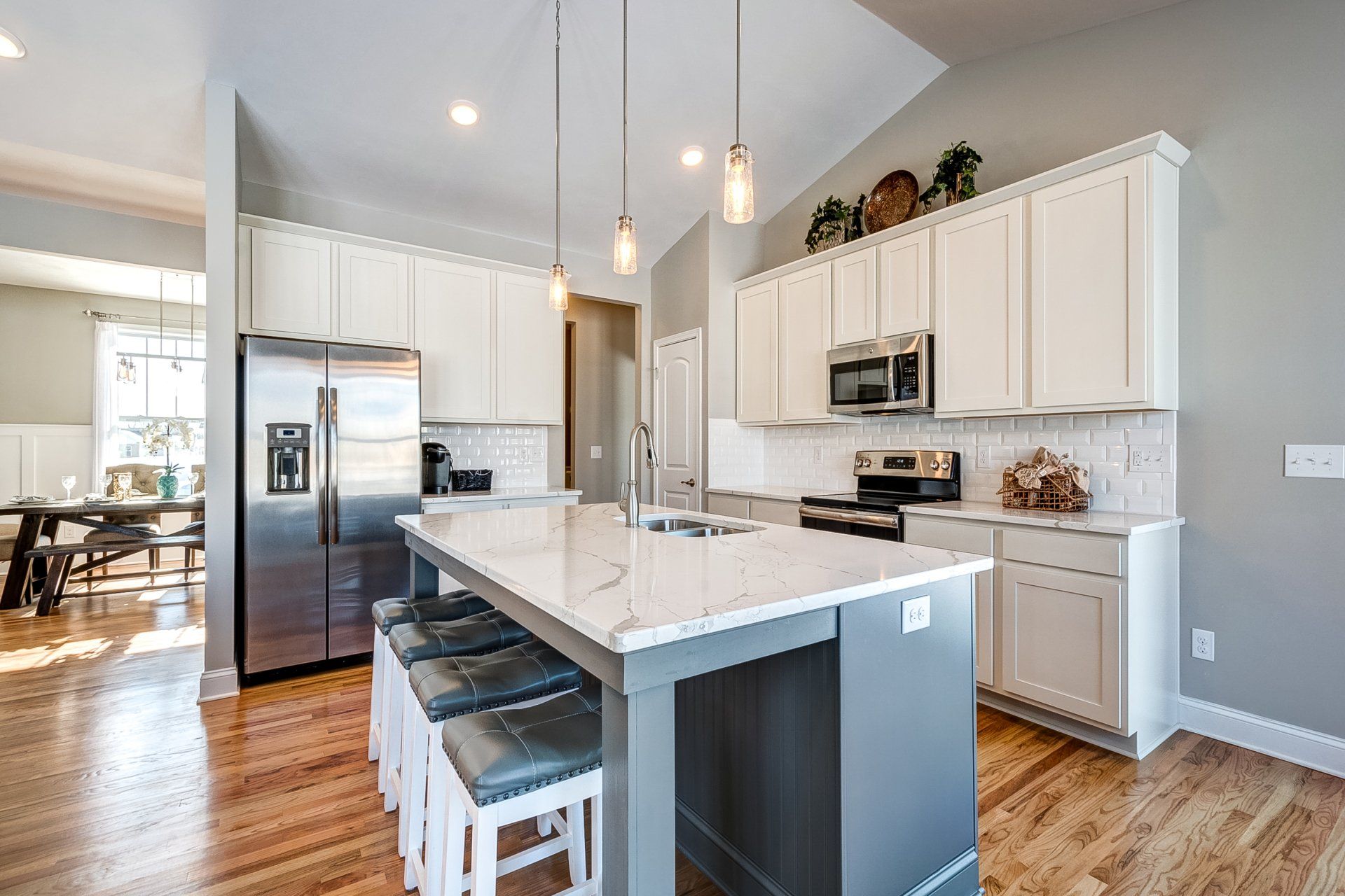 pendant lighting above kitchen island with seating