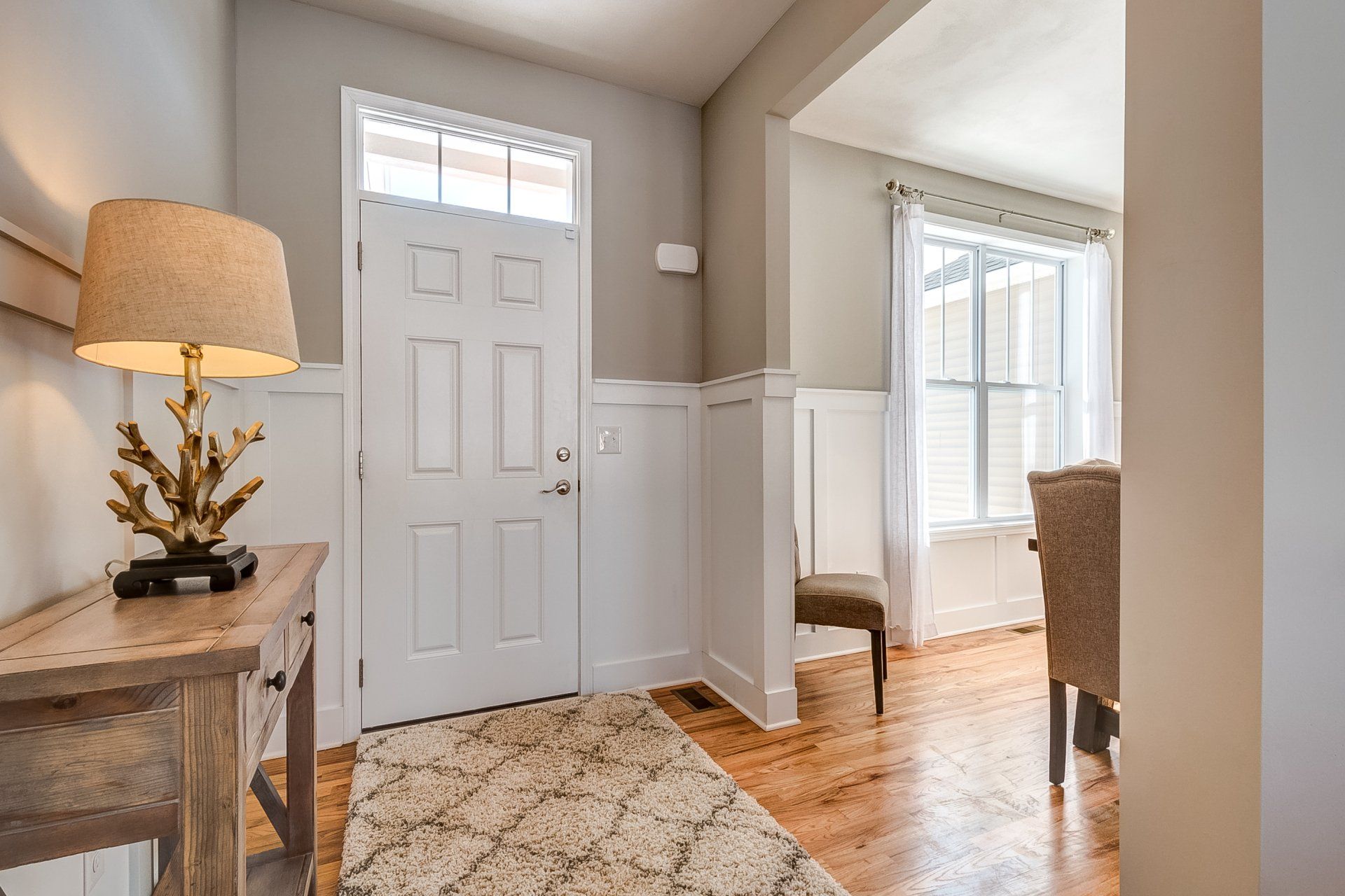 front entryway with console table with dinning room to the right