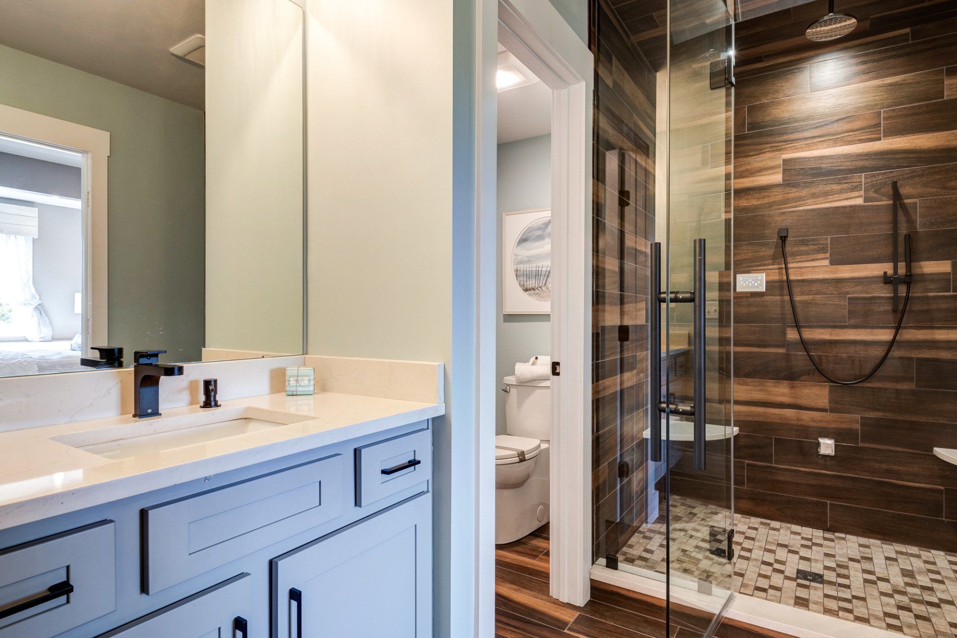 vanity, water closet, and shower