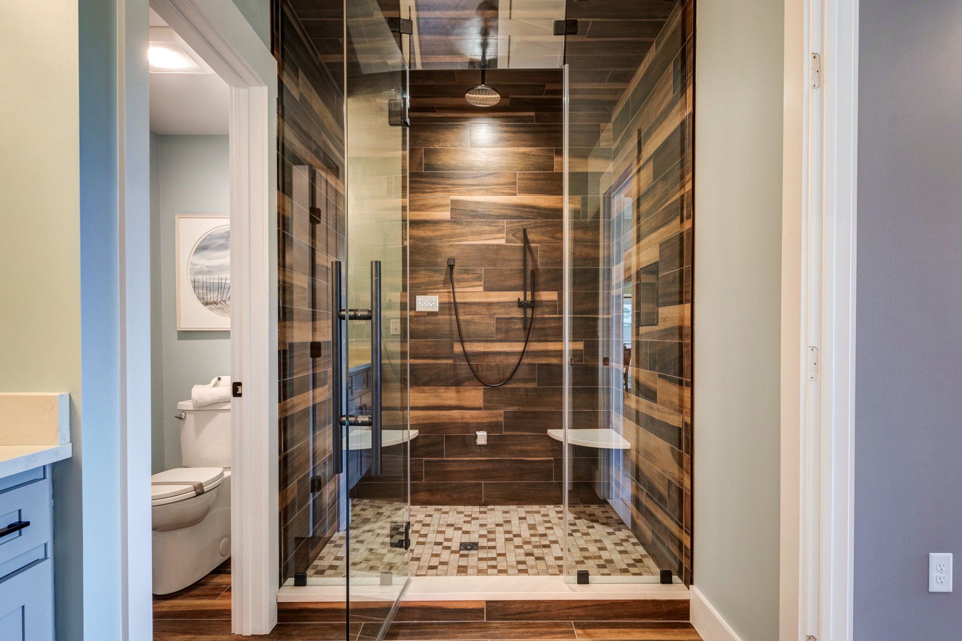 tile shower with glass door and water closet