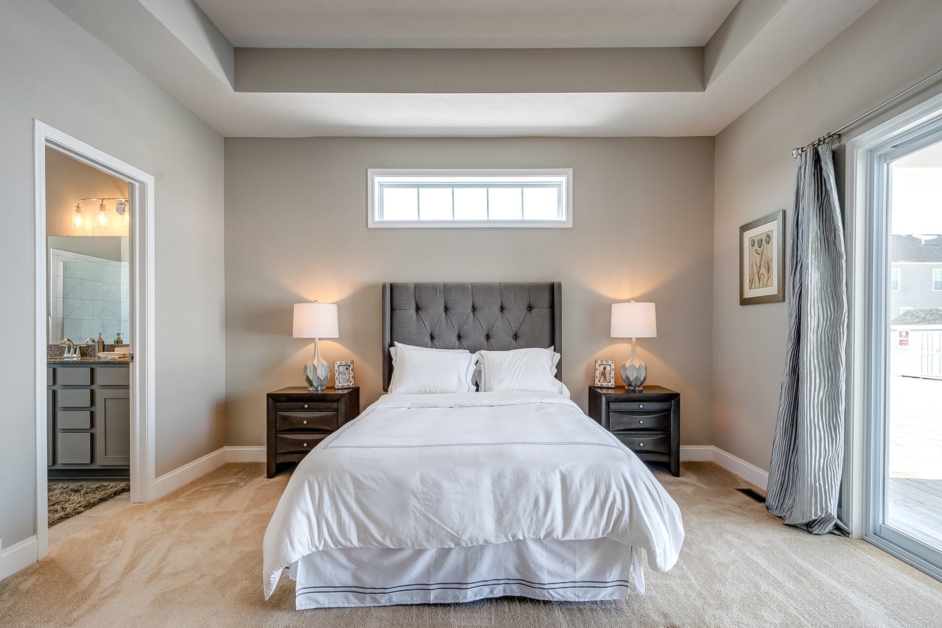 primary bedroom with recessed ceiling