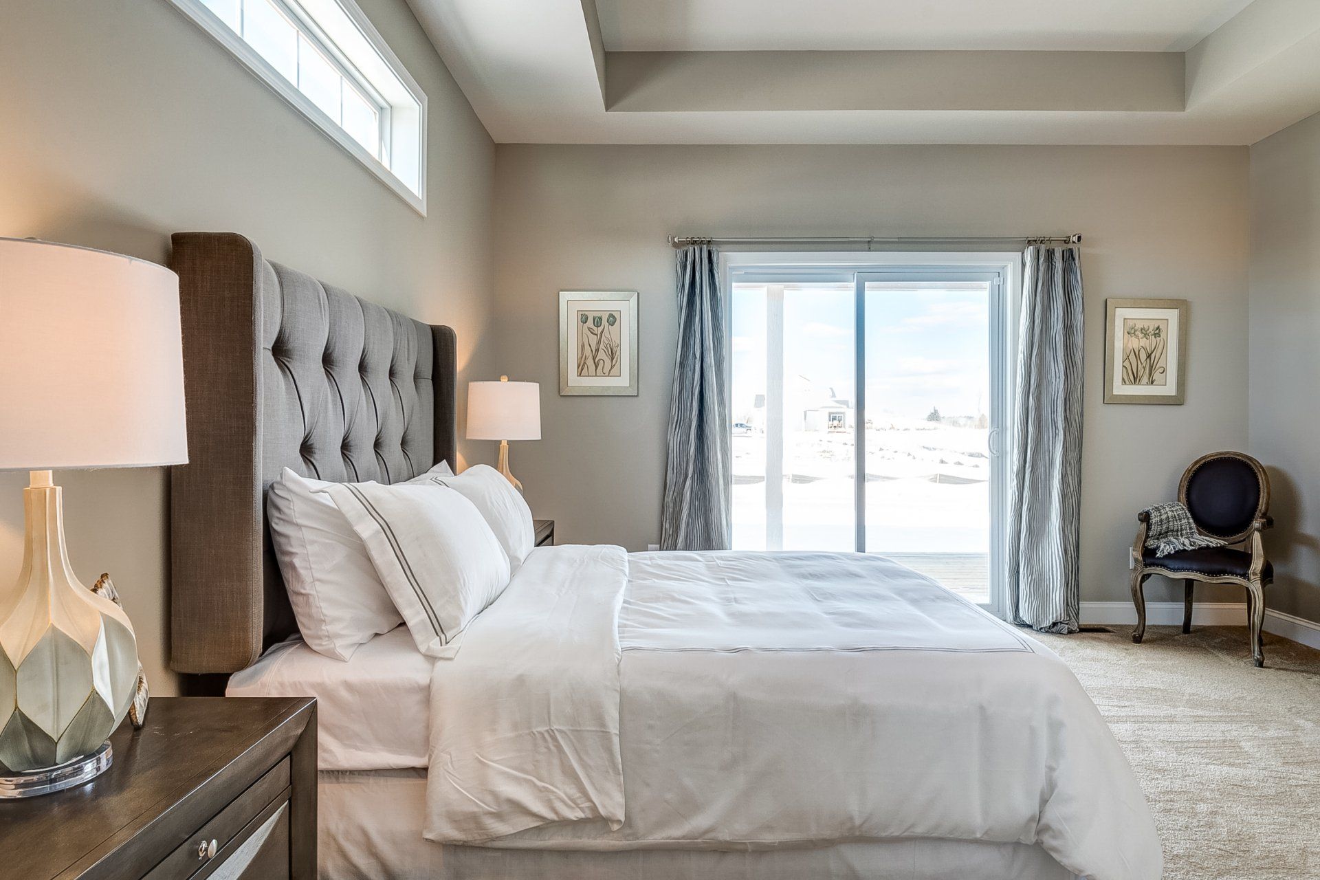 primary bedroom with recessed ceiling and deck access