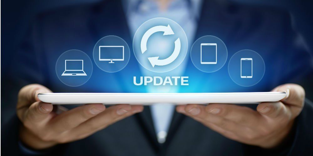 A man is holding a tablet with a screen that says update.