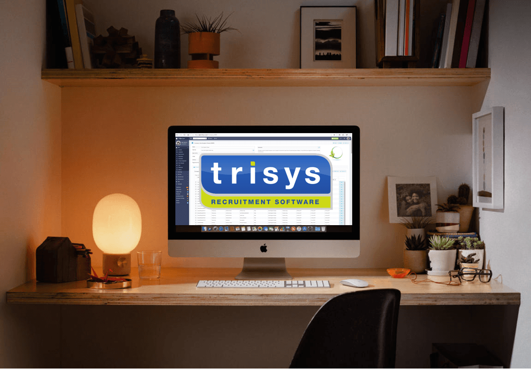 A computer on a desk with the word trisys on the screen
