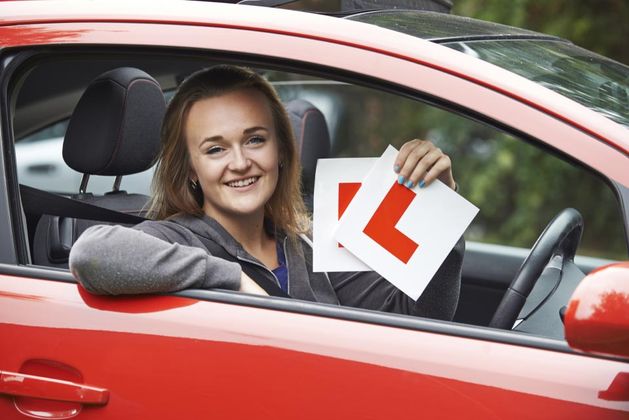 girl holding a learner sign