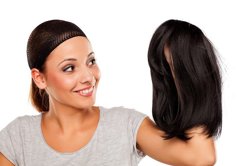 Woman Holding A Wig — Miami, FL & Sunrise, FL — Elite Designer Wigs & Hair Extensions
