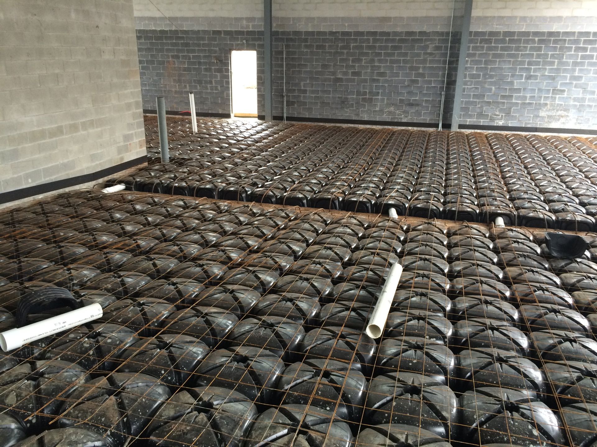 A large room with a brick wall and a concrete floor.