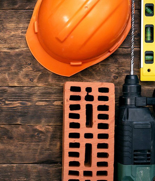 Hardhat, Brick, Hammer Drill, And A Bubble Level — Bricklayers in Yeppoon, QLD