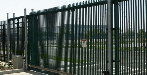 Green metal security fence and gate.