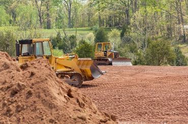 Large earth mover digger clearing land