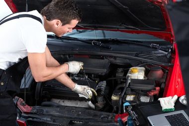 mechanic servicing car