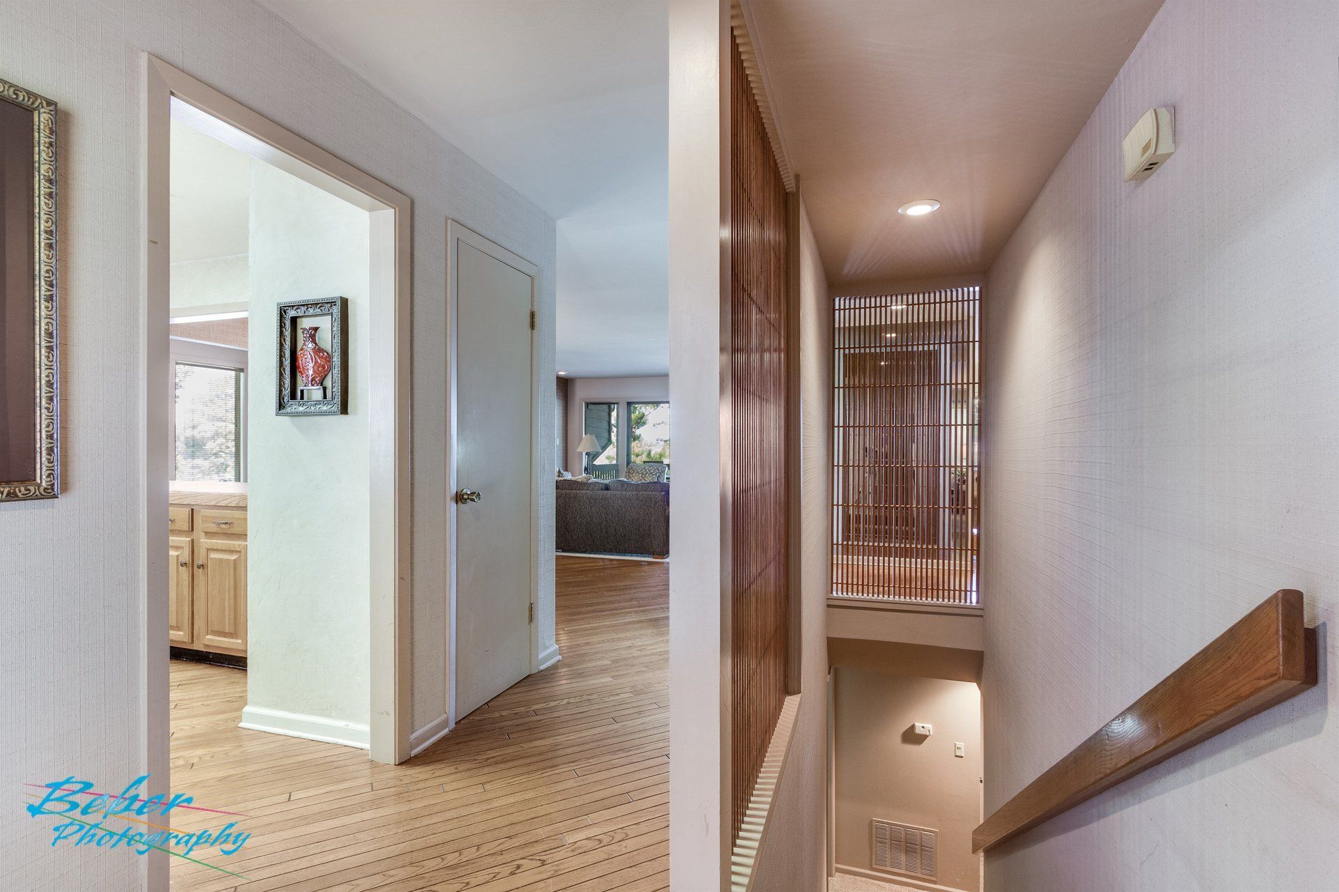A hallway with stairs leading up to the second floor of a house.