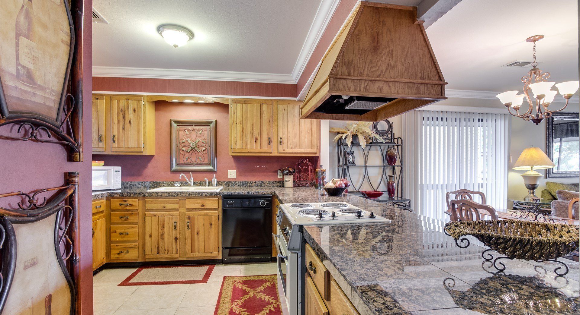 A kitchen with wooden cabinets and granite counter tops