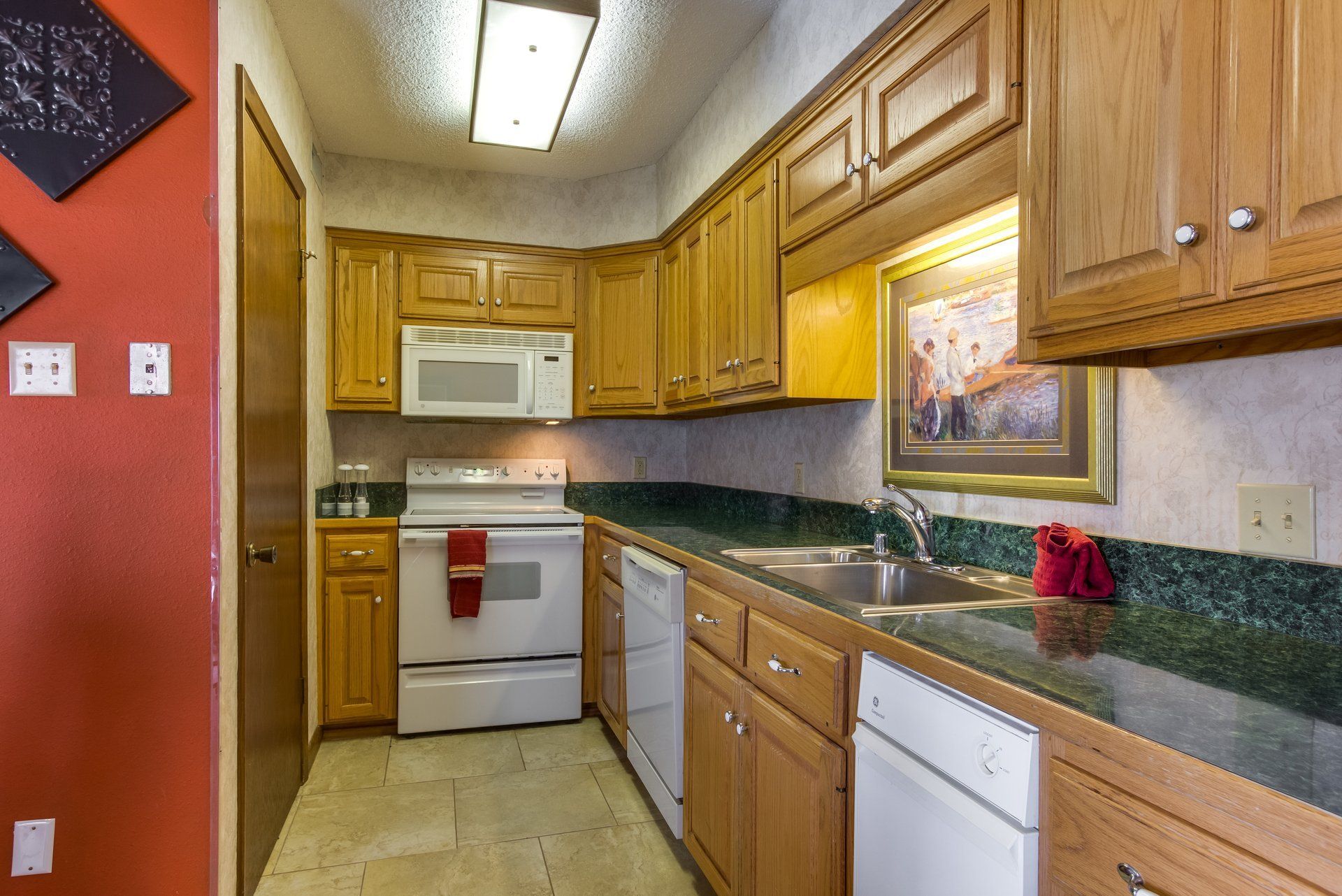 A kitchen with wooden cabinets and white appliances