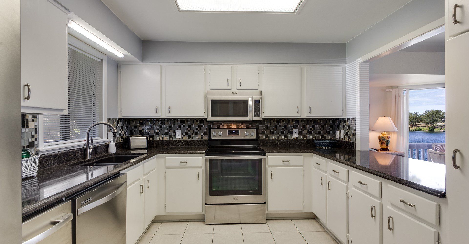 A kitchen with white cabinets and stainless steel appliances