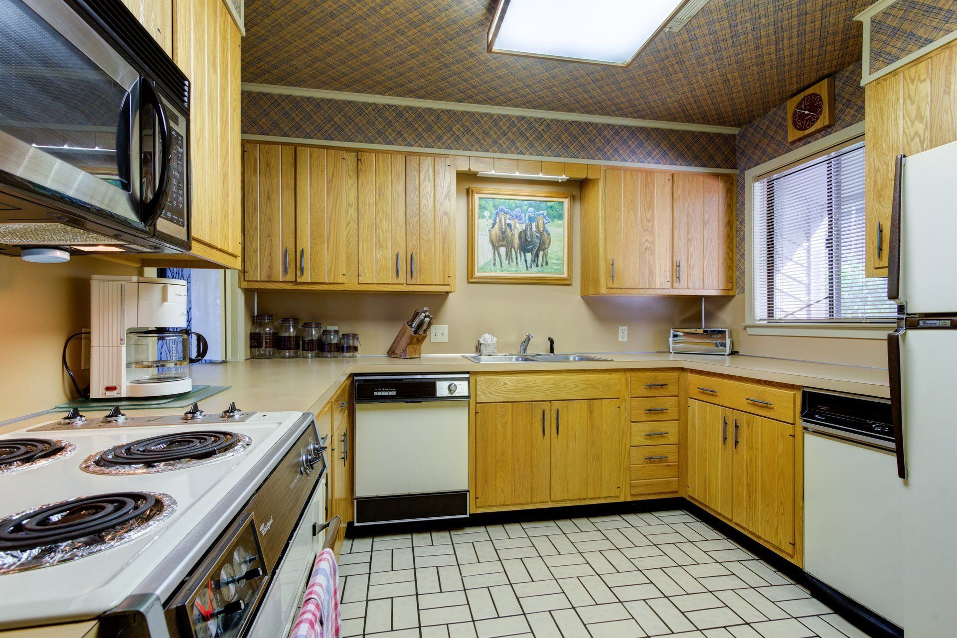 A kitchen with wooden cabinets and a white refrigerator