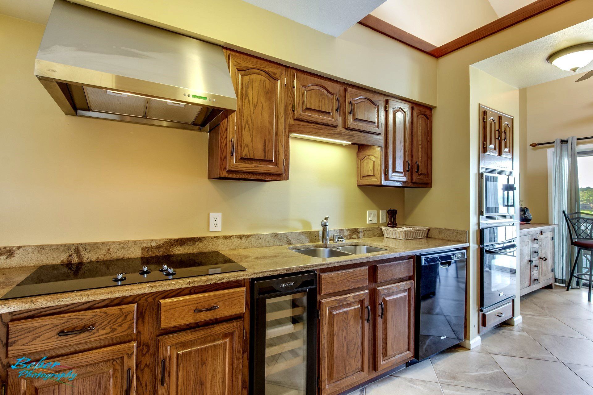 A kitchen with wooden cabinets and stainless steel appliances