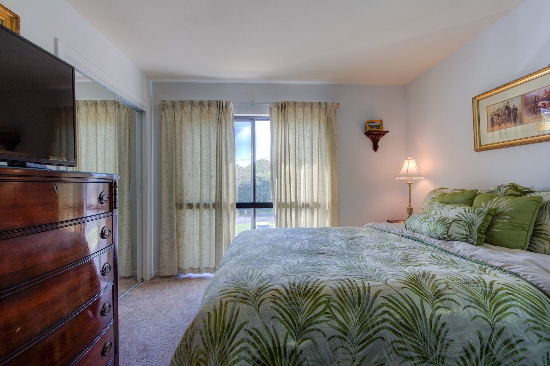 Bed with flora pattern in front of dresser Willow Beach B9