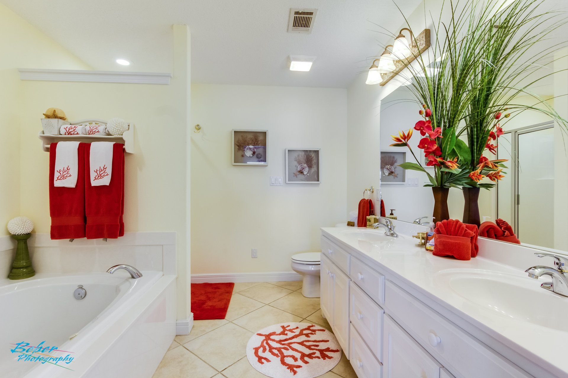 A bathroom with a tub , sink , toilet and mirror.