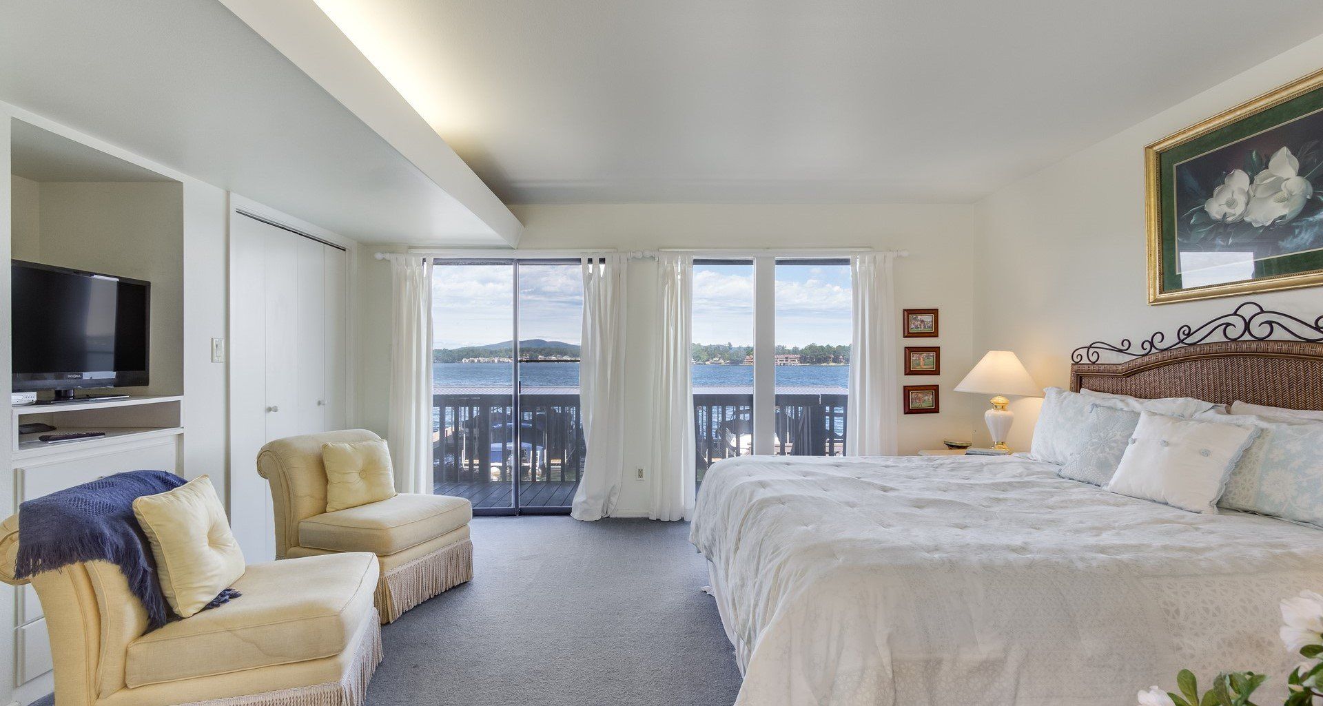 A hotel room with two beds , a chair and a television.