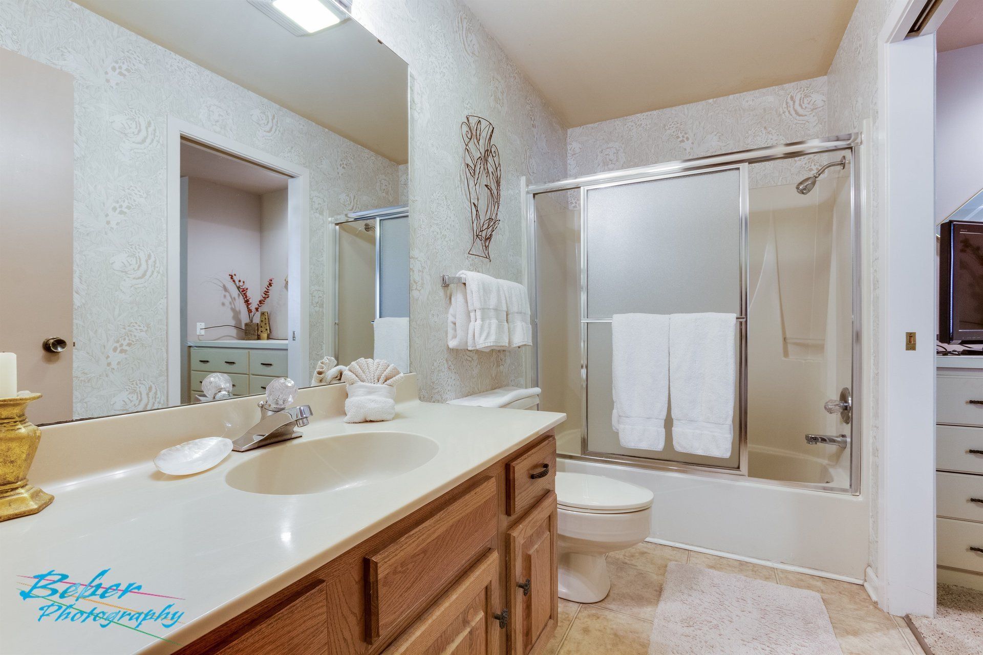 A bathroom with a sink , toilet , and shower.