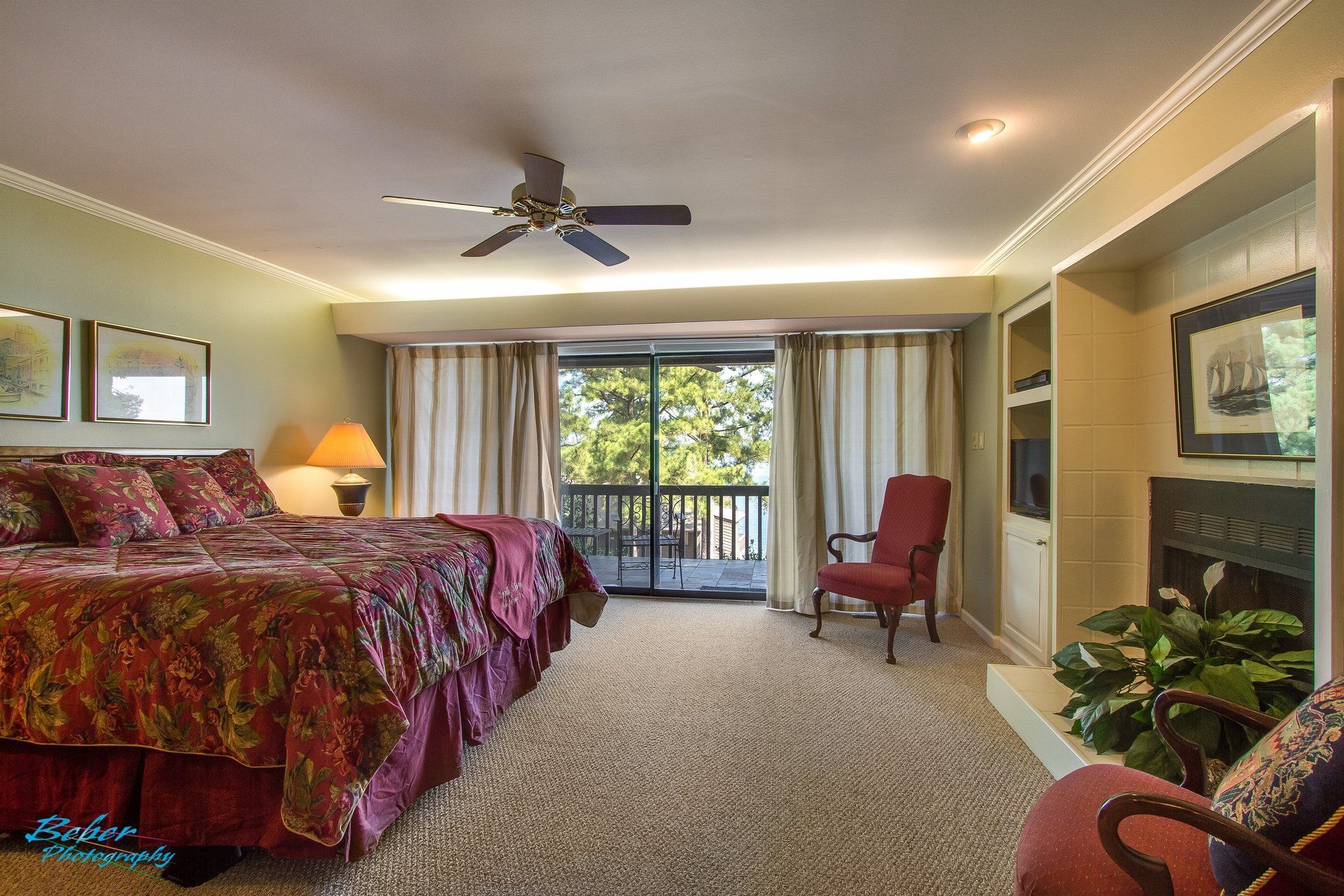 A bedroom with two beds and a ceiling fan
