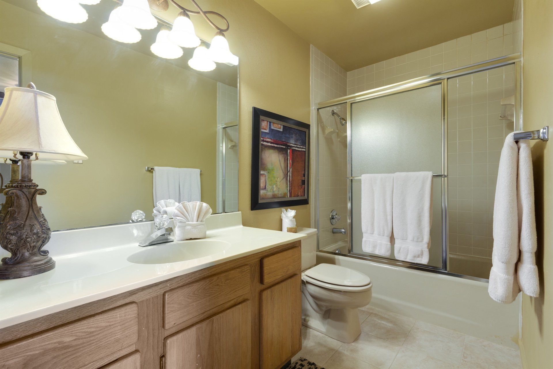 A bathroom with a sink , toilet , and shower.