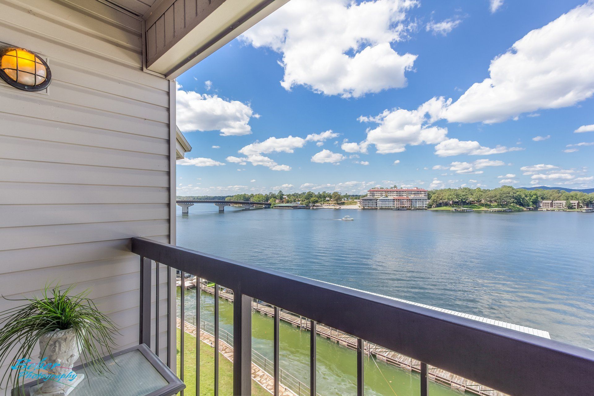 A balcony with a view of a lake and a bridge.