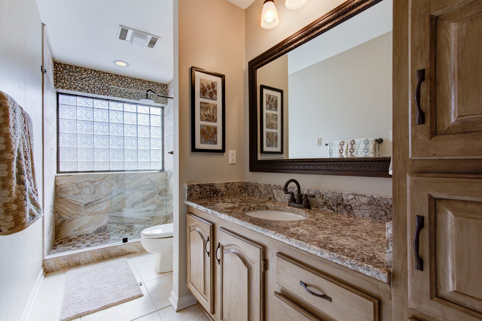 A bathroom with a sink , mirror and toilet