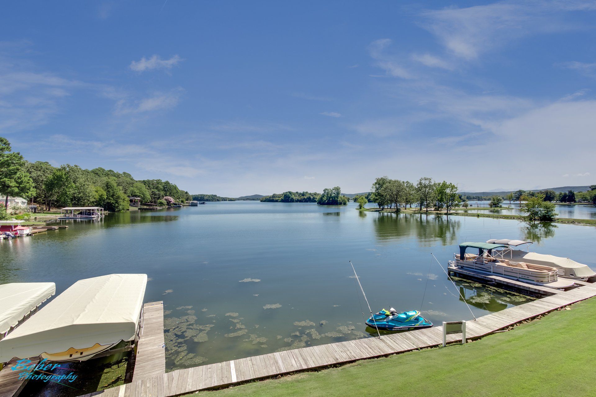 A large body of water with a dock and boats in it.