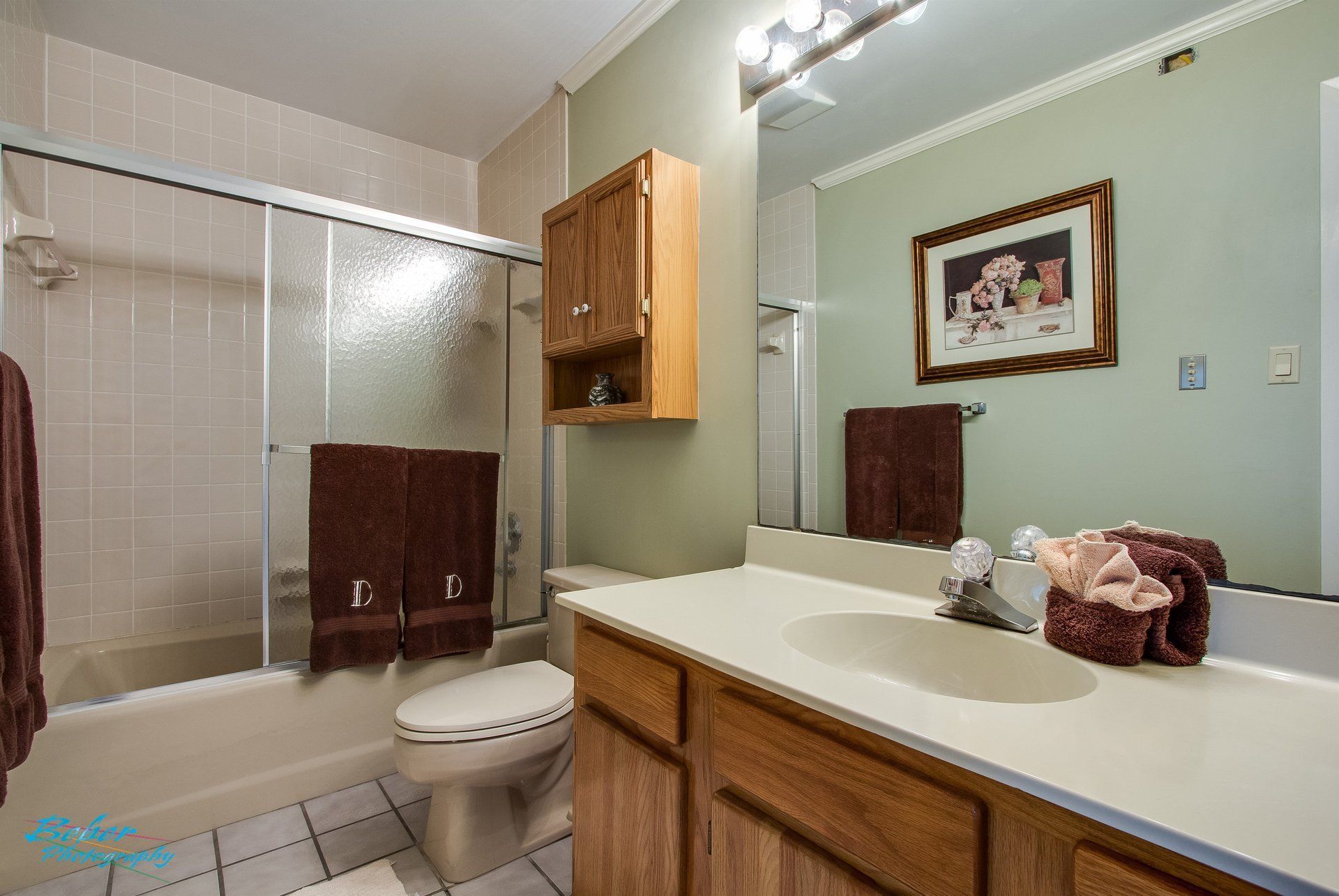 A bathroom with a toilet , sink , and shower.