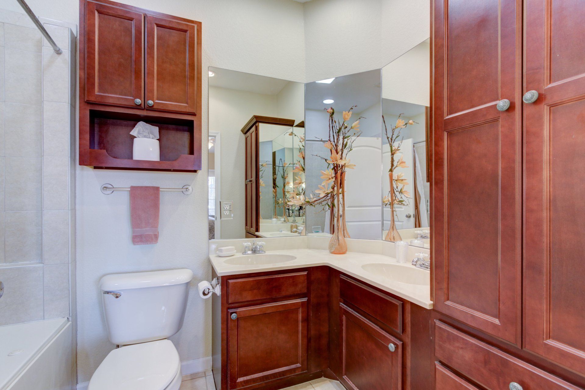 A bathroom with a toilet , sink , and mirror.