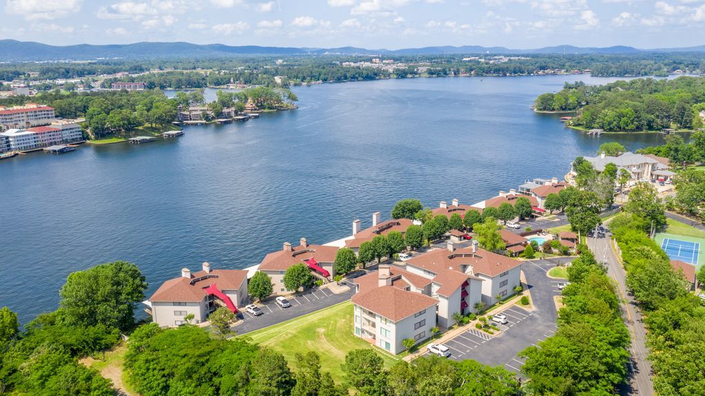 An aerial view of a lake surrounded by buildings and trees.