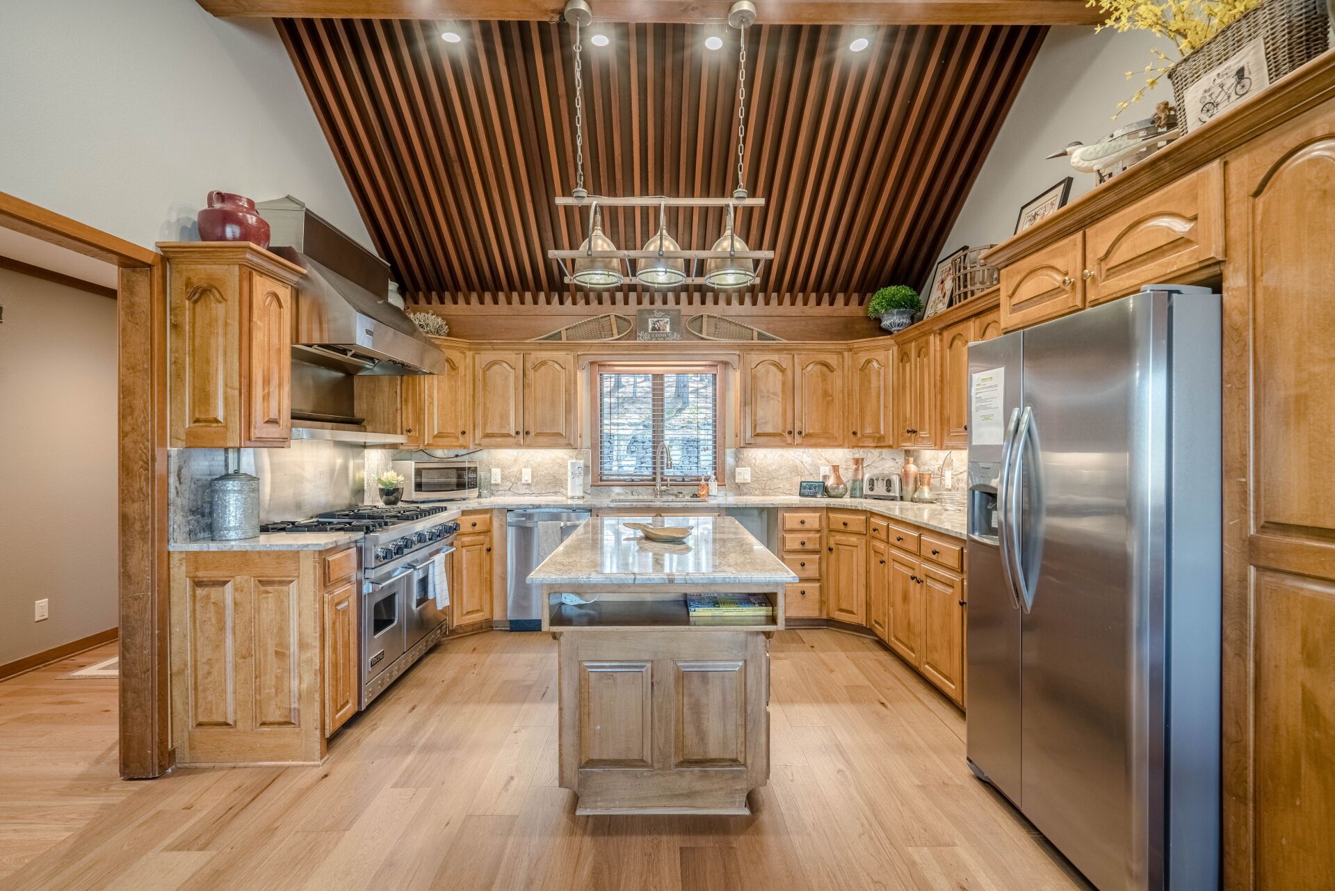 A large kitchen with wooden cabinets and stainless steel appliances.